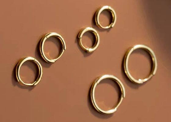 گوشواره حلقه ای طلای 14 عیار سکسی هلیکس ODM برای زنان با ابعاد 1.2 میلی متر × 10 میلی متر